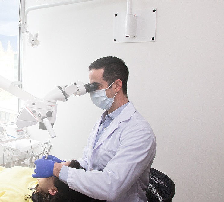 Dr. Yale Winestock treating a patient under the surgical microscope